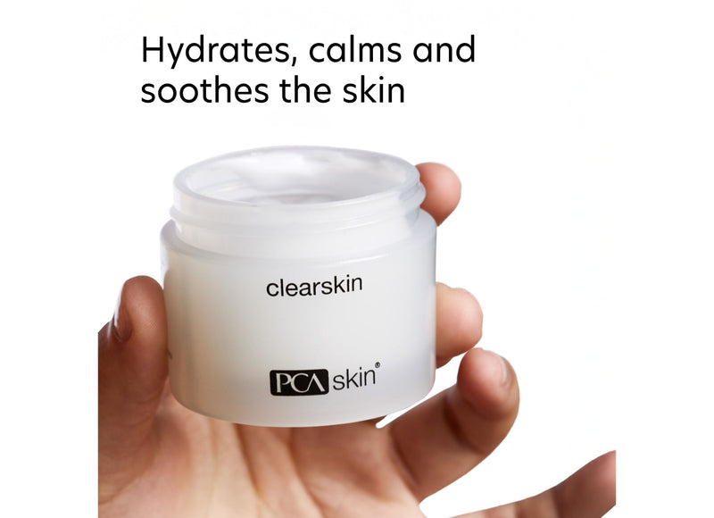 Hand holding a jar of PCA Skin Clearskin cream  with text on a white background
