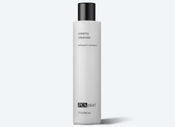 A bottle of PCA SKIN Creamy Cleanser against a white background.