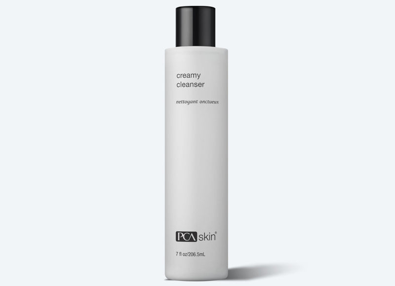 A bottle of PCA SKIN Creamy Cleanser against a white background.